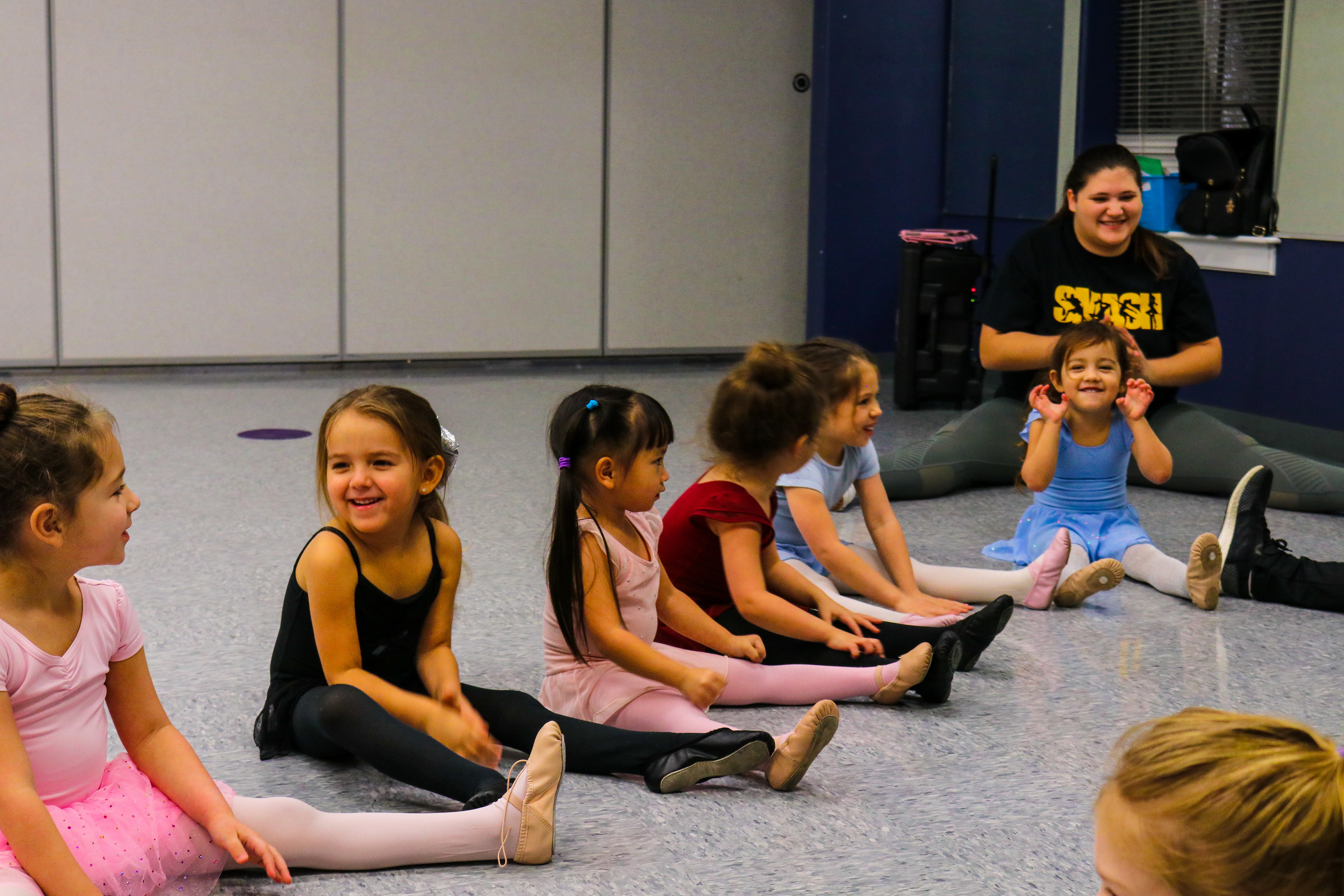 Tiny dancers seated with an instructor