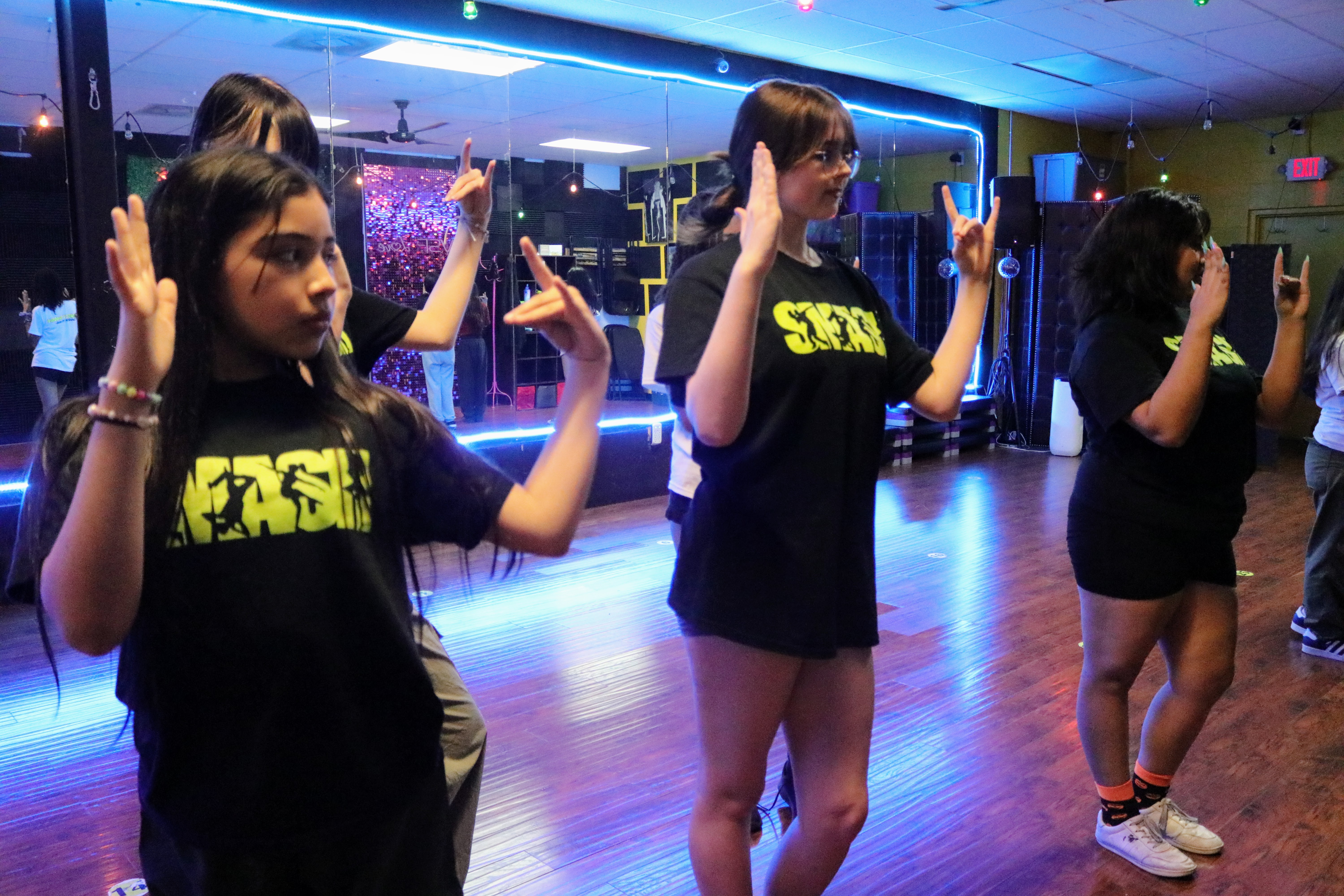 Kids practicing a dance move together
