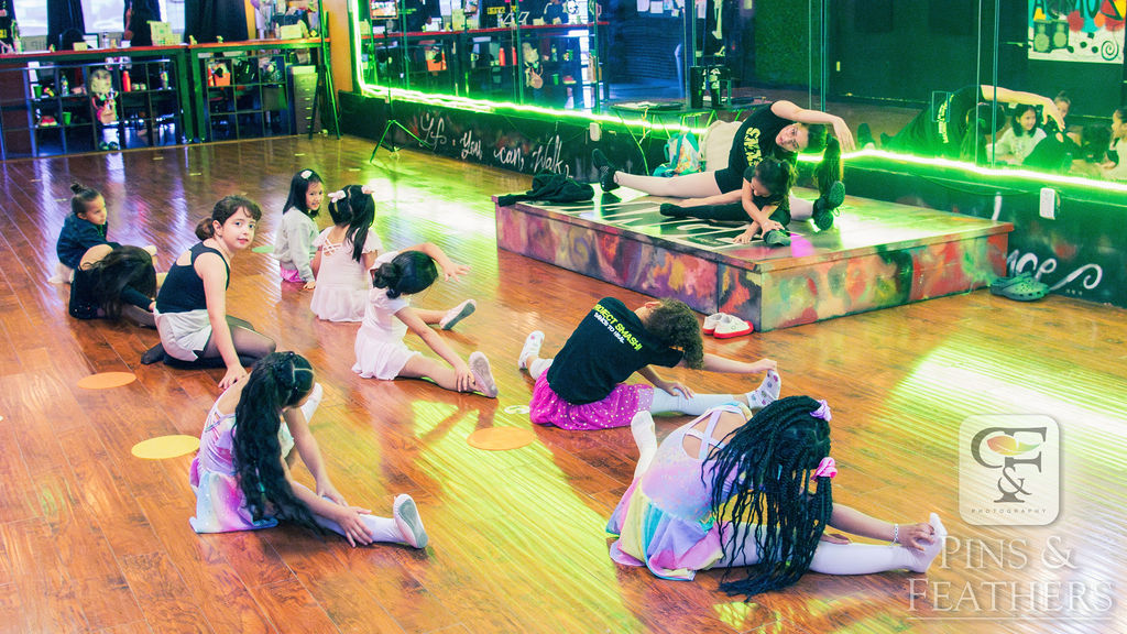 Young dancers stretching in the studio