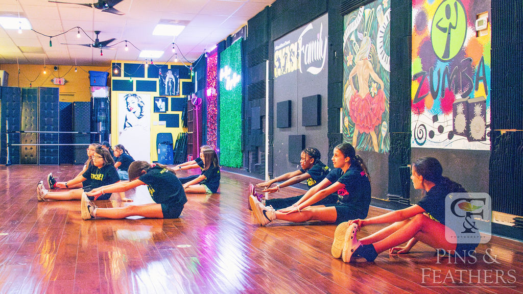 Young dancers stretching together