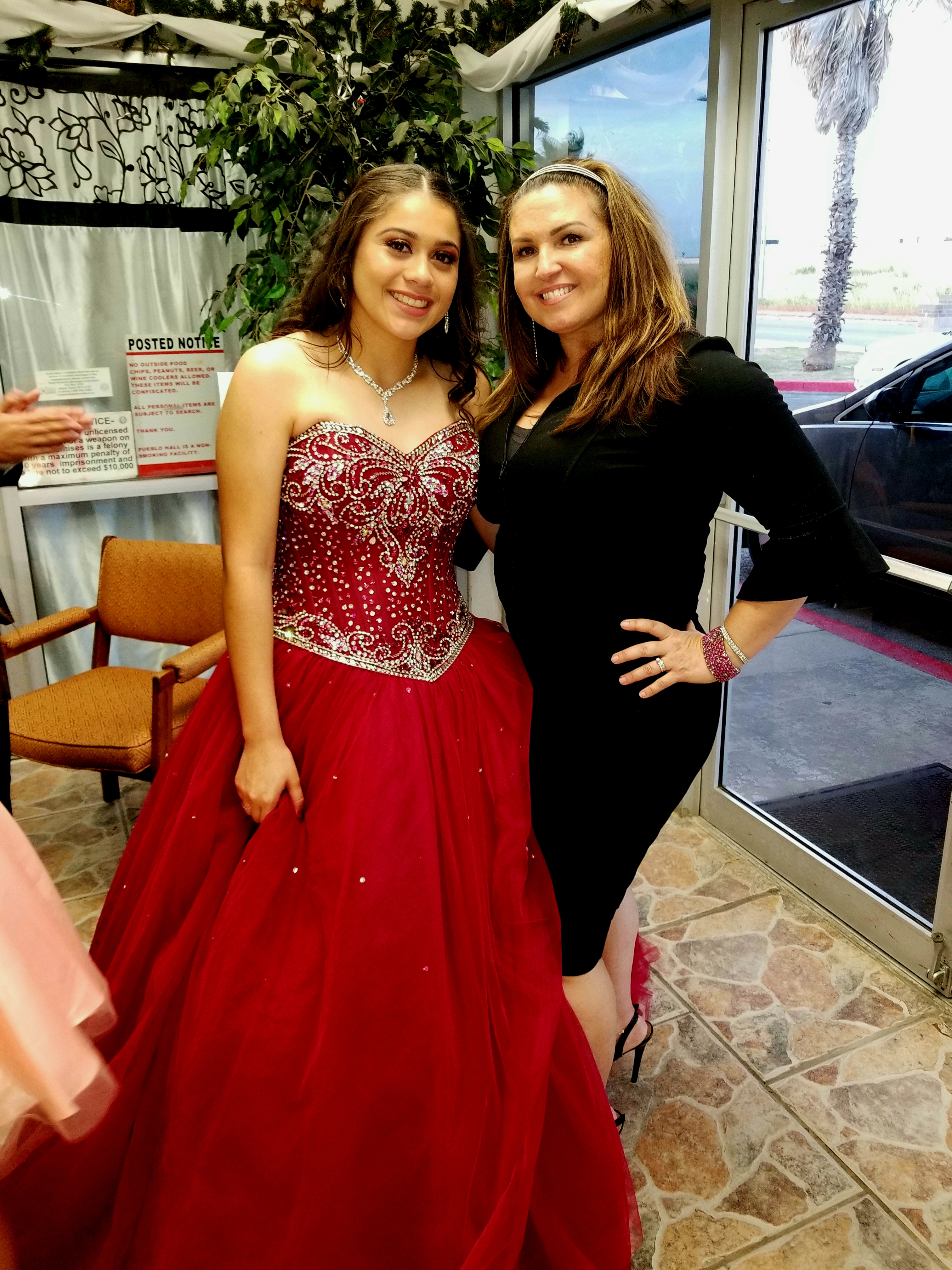 Quinceañera in a red dress with her instructor