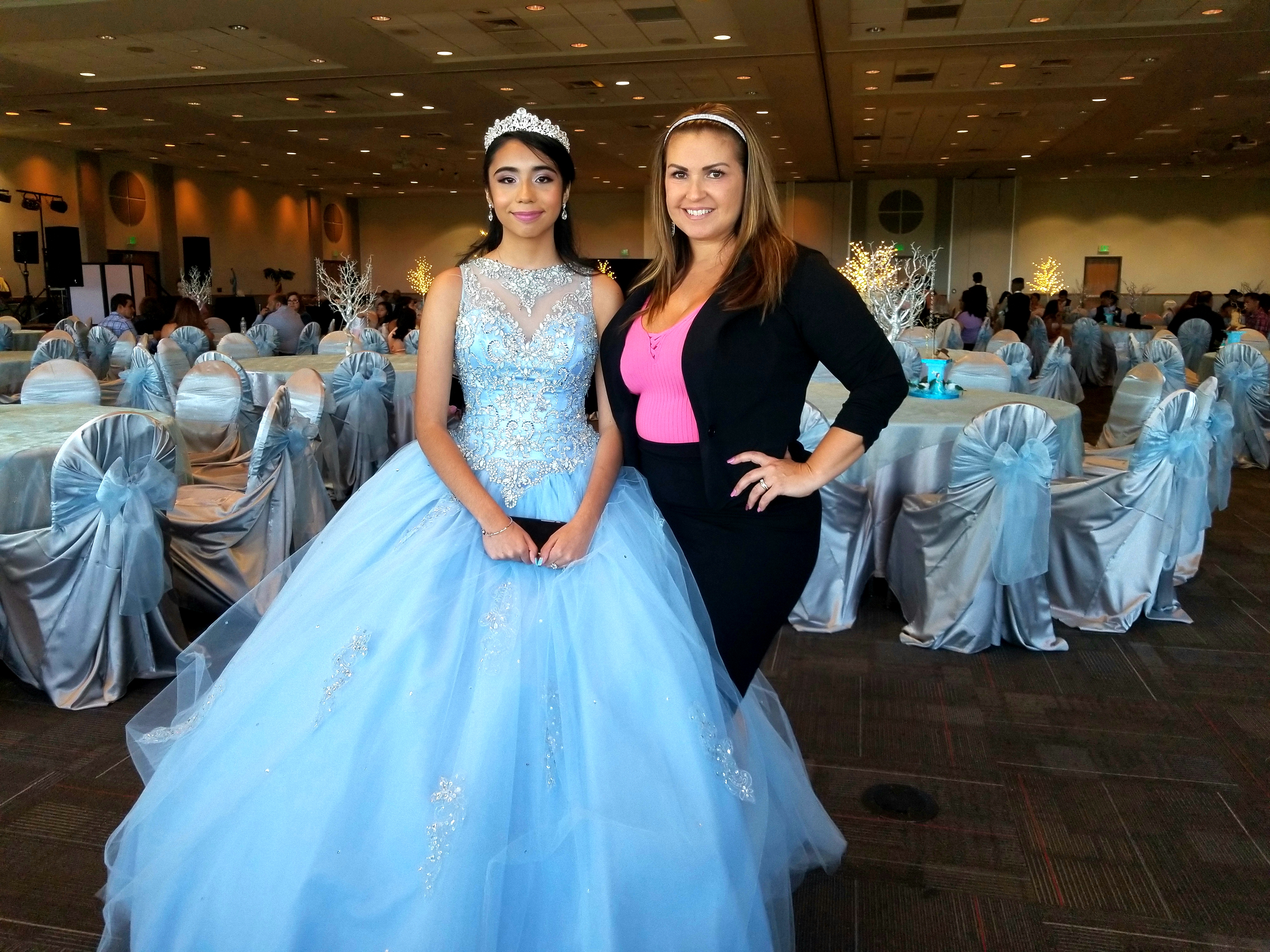 Quinceañera in a blue dress with her instructor